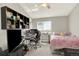 Bedroom with built-in shelving and a desk for a functional workspace at 13271 Holly St # B, Thornton, CO 80241