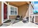 Inviting front porch with chairs and a side table, an ideal spot for morning coffee at 13271 Holly St # B, Thornton, CO 80241