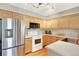 Bright kitchen with stainless steel refrigerator and natural wood cabinets at 13271 Holly St # B, Thornton, CO 80241