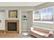 Charming living room with fireplace, seating, and natural light from a large window at 13271 Holly St # B, Thornton, CO 80241