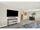 Open-concept living room with view to kitchen and dining, creating a great flow for entertaining at 13271 Holly St # B, Thornton, CO 80241