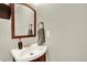 Traditional powder room features pedestal sink, stylish fixtures, and a framed vanity mirror at 13271 Holly St # B, Thornton, CO 80241