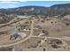 Expansive aerial view of a community with stunning mountain views and a tranquil lake at 5265 Club Ct, Larkspur, CO 80118