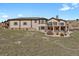 Large backyard with multi-level patios and stone accents, perfect for entertaining at 5265 Club Ct, Larkspur, CO 80118