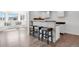 Wet bar features countertop seating, scenic outdoor views, and modern decor at 5265 Club Ct, Larkspur, CO 80118