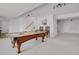 Entertainment area boasts a pool table and is adjacent to the stairs at 5265 Club Ct, Larkspur, CO 80118