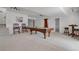 Basement with a pool table, stairs, a seating area, and neutral carpeting at 5265 Club Ct, Larkspur, CO 80118