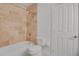 Bathroom with tub and shower combination featuring neutral tiling and bright lighting at 5265 Club Ct, Larkspur, CO 80118