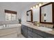Bathroom with double sinks, tub, and window view at 5265 Club Ct, Larkspur, CO 80118