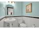 Charming half-bathroom with pedestal sink, subway tile and lovely light-blue paint at 5265 Club Ct, Larkspur, CO 80118