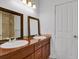 Bathroom with double sink vanity, warm lighting and large framed mirrors at 5265 Club Ct, Larkspur, CO 80118