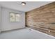 Bedroom features a window and a striking accent wall with wood paneling at 5265 Club Ct, Larkspur, CO 80118