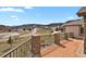 Outdoor deck with stone pillars and metal railings with beautiful mountain views at 5265 Club Ct, Larkspur, CO 80118