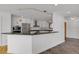 Modern kitchen featuring white cabinets, granite countertops, stainless steel appliances, and slate floors at 5265 Club Ct, Larkspur, CO 80118