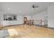 Bright open-concept living room and kitchen area with hardwood floors and white cabinets at 5265 Club Ct, Larkspur, CO 80118
