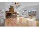 Bright living room featuring a stone fireplace, vaulted ceilings, and hardwood floors at 5265 Club Ct, Larkspur, CO 80118