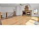 Spacious living room featuring a stone fireplace, hardwood floors and a staircase with metal spindles at 5265 Club Ct, Larkspur, CO 80118