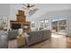 Bright living room featuring a stone fireplace, vaulted ceilings, hardwood floors and mountain views at 5265 Club Ct, Larkspur, CO 80118