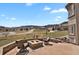 Outdoor patio with stone firepit and scenic views, ideal for relaxation and gatherings at 5265 Club Ct, Larkspur, CO 80118
