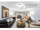 Finished basement showcasing a cozy living area with a leather couch and decorative accents at 9325 Meade St, Westminster, CO 80031