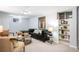 Basement living room with black sofa and built-in bookcase at 9325 Meade St, Westminster, CO 80031