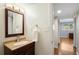 Bathroom vanity featuring a wooden cabinet, ample lighting, and white towel at 9325 Meade St, Westminster, CO 80031