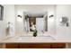 Bathroom featuring a dual sink vanity, modern lighting, and a mirror at 9325 Meade St, Westminster, CO 80031
