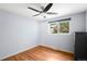 This bedroom features hardwood floors, a ceiling fan, and a large window at 9325 Meade St, Westminster, CO 80031