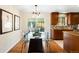 Dining area with glass table and modern chandelier, adjacent to kitchen at 9325 Meade St, Westminster, CO 80031