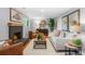 Bright living room features a fireplace, hardwood floors, and stylish contemporary decor at 9325 Meade St, Westminster, CO 80031
