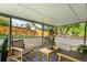 Covered outdoor patio featuring comfortable seating with a well-maintained backyard view at 9325 Meade St, Westminster, CO 80031