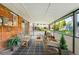 Covered patio with brick features, outdoor seating, and views of the landscaped backyard at 9325 Meade St, Westminster, CO 80031