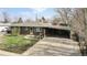 Brick ranch house with carport and fenced yard at 1242 Elder St, Denver, CO 80221