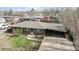 Brick ranch house with carport, driveway and yard at 1242 Elder St, Denver, CO 80221