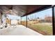 Covered patio with seating area, overlooking a fenced backyard with garden at 1242 Elder St, Denver, CO 80221