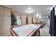 Basement with air hockey table and a view of the living area at 1242 Elder St, Denver, CO 80221