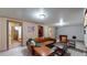 Finished basement with sectional sofa and adjacent bathroom at 1242 Elder St, Denver, CO 80221