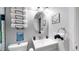 Clean bathroom, featuring a gray vanity and updated fixtures at 1242 Elder St, Denver, CO 80221