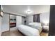 Basement bedroom with queen bed and views into a game room at 1242 Elder St, Denver, CO 80221