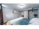 Spacious basement bedroom with a queen-size bed and large TV at 1242 Elder St, Denver, CO 80221
