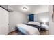 Cozy basement bedroom with a comfortable queen-size bed and access to a private closet at 1242 Elder St, Denver, CO 80221