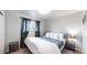 Bedroom with a king-size bed and window with teal curtains at 1242 Elder St, Denver, CO 80221