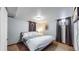Bright basement bedroom with a queen bed and two windows at 1242 Elder St, Denver, CO 80221