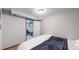 Basement bedroom with a queen bed, offering views into a nearby Gathering room at 1242 Elder St, Denver, CO 80221