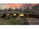 Brick ranch home with carport, lit at night at 1242 Elder St, Denver, CO 80221