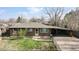 Brick ranch home with carport and fenced yard at 1242 Elder St, Denver, CO 80221