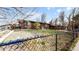 Brick ranch house with a carport and a chain link fence at 1242 Elder St, Denver, CO 80221