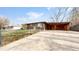 Brick ranch house with carport and driveway at 1242 Elder St, Denver, CO 80221