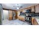 Bright kitchen, stainless steel appliances, and ample wood cabinetry at 1242 Elder St, Denver, CO 80221