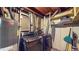 Basement laundry room with washer, dryer, and storage shelves at 1242 Elder St, Denver, CO 80221